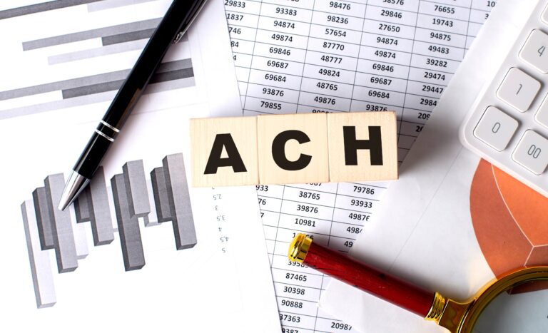 Wooden Block Letters ACH on graph background with pen