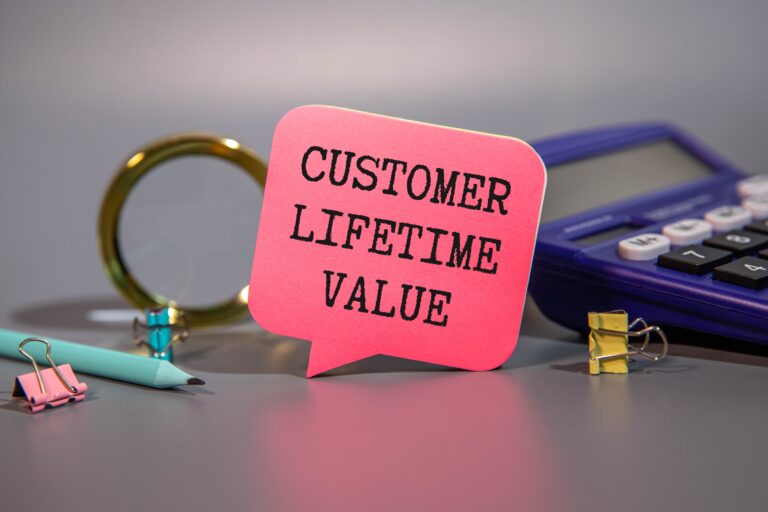 customer lifetime value words on a piece of paper with office supplies