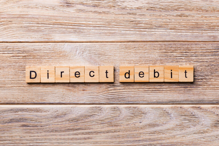 wooden blocks spelling out direct debit