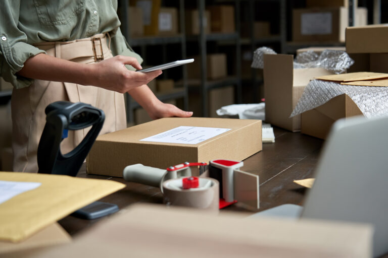 person looking at smartphone with a package